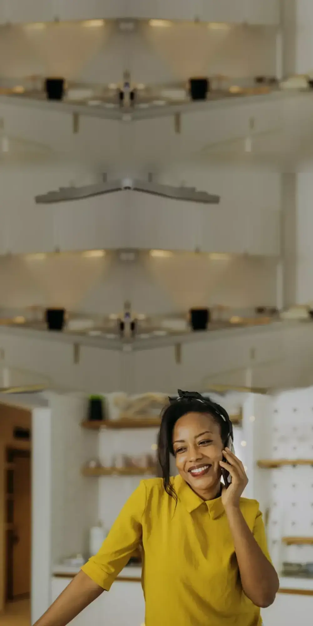 Woman talking on her mobile in kitchen